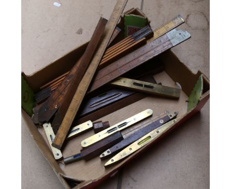 A box with Vintage rules, and various brass-mounted spirit levels, including Rabone, Sorby and Marples 