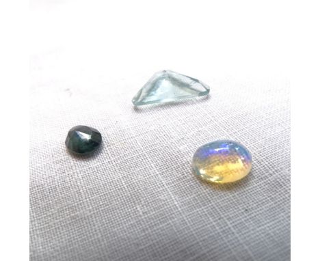 3 unmounted gemstones, comprising 4.46ct triangular step-cut fluorite, 1.29ct oval cabochon opal, and 1.42ct oval sapphire, a
