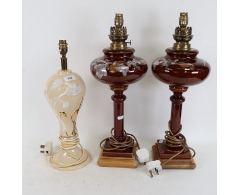 A pair of ceramic table lamps, on wooden plinths, height 53cm, and another 