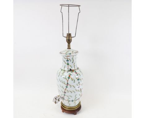 An Oriental porcelain table lamp, on wooden stand, with painted decoration, height 62cm overall 