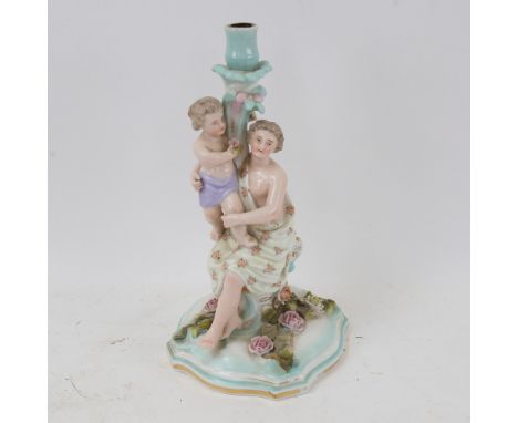 A Continental porcelain candlestick, supported by Classical mother and child figures, 30cm 