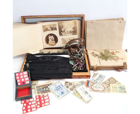 A table-top display case, with coins and Continental banknotes, a dried flower press, spurs, a Vintage photo album - topograp