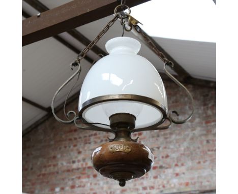 An Antique brass-mounted mahogany ceiling light fitting, with large milk glass shade and clear glass funnel, height approx 65