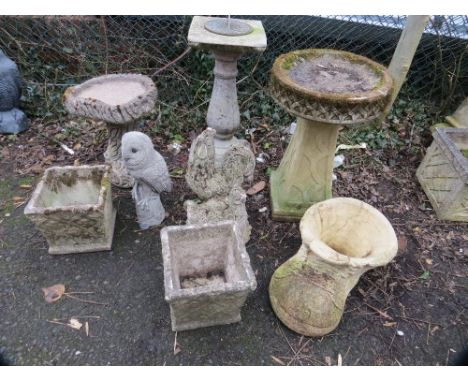 A selection of concrete garden statues and planters to include a sundial 