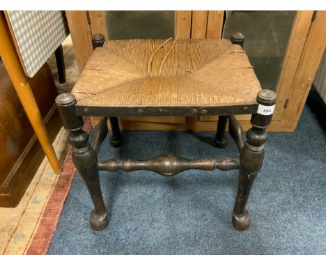 A vintage oak and wicker seat stool 