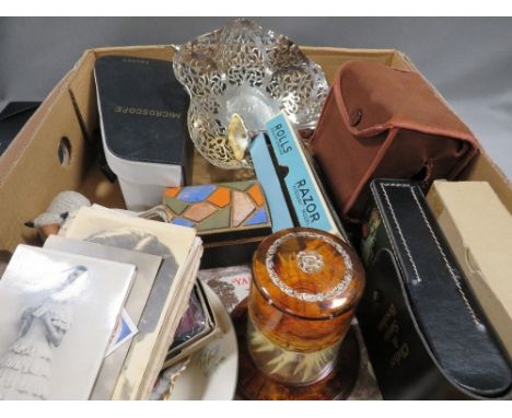 A tray of collectables to include vintage saucy postcards etc, small boxed microscope, vintage razor etc