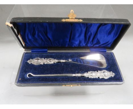 A hallmarked silver handled button hook and shoe horn set 