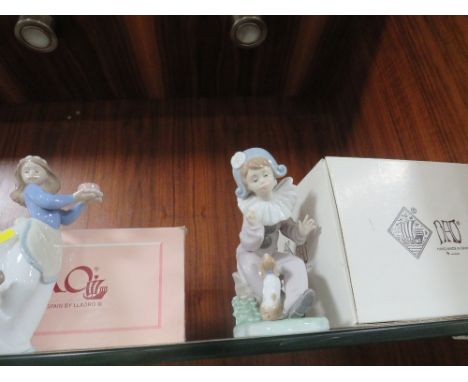 Three boxed Nao figurines and one unboxed of a mother kissing a child 