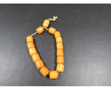 A string of vintage amber prayer beads, approx 20.5 g, middle bead 1 cm x 1 cm