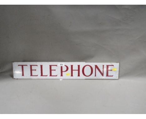 A vintage plastic telephone sign insert 