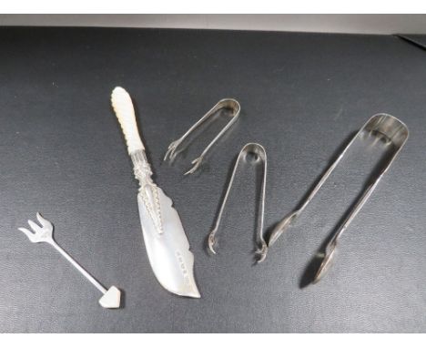 A small collection of hallmarked silver consisting of two small pairs of ice tongs, a pair of sugar tongs, a small pickle for