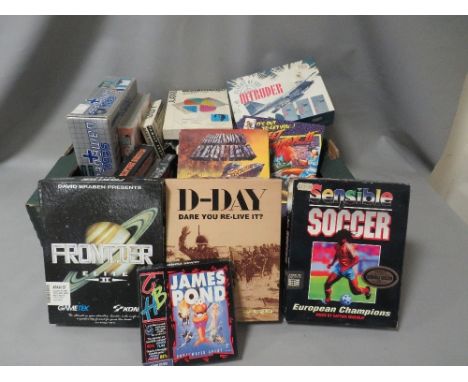 A tray of boxed vintage Atari and Sega computer games to include street fighter and sensible soccer  (unchecked) 