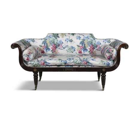 A REGENCY MAHOGANY FRAMED SOFA CIRCA 1815upholstered in floral fabric, the reeded frame carved with gilt rosettes to the arm 