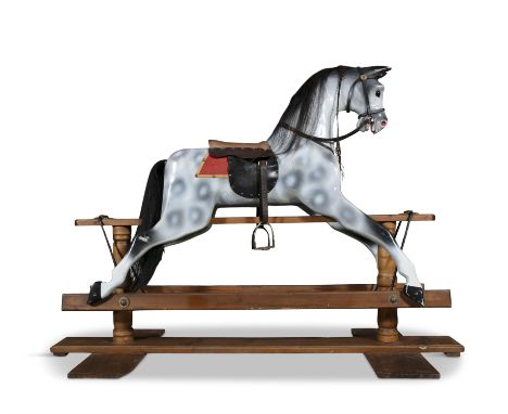 AN EDWARDIAN PAINTED TIMBER ROCKING HORSE, painted in white and grey tones, with saddle and stirrups. The base 169cm long, 12