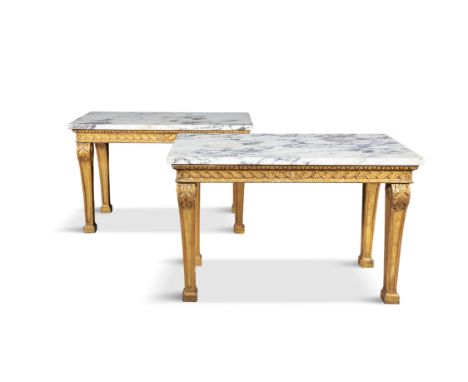 A PAIR OF GILTWOOD AND MARBLE TOP CONSOLE TABLES IN THE STYLE OF WILLIAM KENT,the white variegated rectangular marble tops, a
