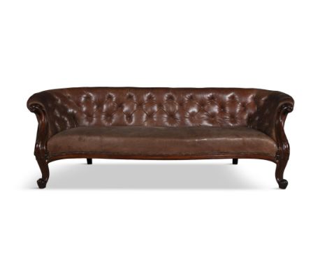 A VICTORIAN BROWN BUTTON BACK LEATHER SETTEE,the carved framed with outscrolled arms, raised on short scroll end supports. 75