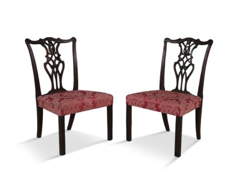 A PAIR OF GEORGE III CARVED MAHOGANY SIDE CHAIRS, each with pierced interlaced splat, covered in a ruby floral damask, on squ