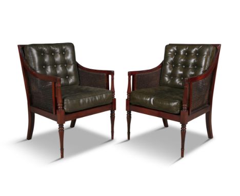A PAIR OF REGENCY STYLE MAHOGANY FRAMED BERGERE LIBRARY CHAIRS 20TH CENTURY,each with square backs and turned column carved a