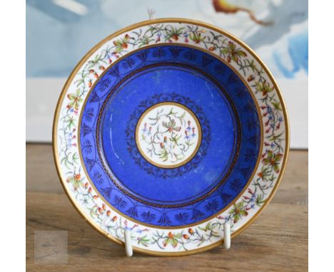 A Sèvres porcelain saucer, finely painted with miniature floral medallion and border on blue ground with gilding, puce mark f