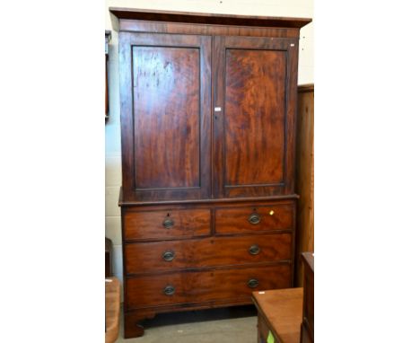 A 19th century figured mahogany linen press (slides replaced by rail), with panelled doors over two short and two long drawer
