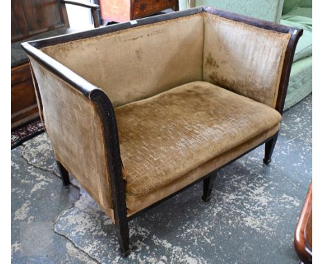 An Edwardian part moulded walnut framed upholstered box sofa, raised on three square tapering front legs, damages to frame an