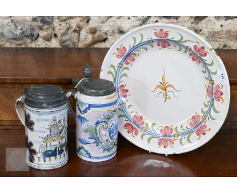 An 18th century English Delft charger, painted with polychrome floral motifs, 35 cm diam to/w two 18th century Delft (or poss