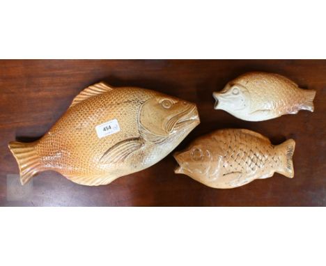 A 19th century Brampton (probably) salt-glazed stoneware flask, modelled as a fish, 34 cm long (repaired), to/w two similar s