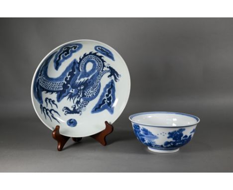 A Chinese transitional style blue and white dragon charger in the mid 17th century manner, painted in tones of underglaze blu