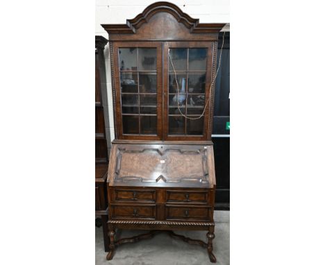 A 17th century style mahogany and walnut bureau bookcase, astragal glazed doors over the fall front panel and four drawers, 9