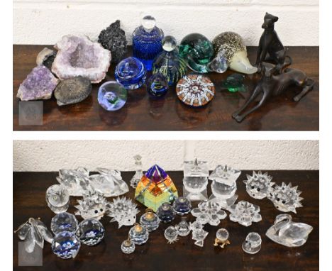 Various glass paperweights, two bronzed dogs, a fossil ammonite, amethyst and other geodes, a collection of Swarovski and sim
