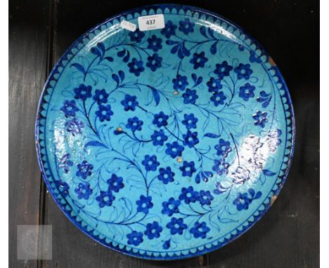 An antique Indo-Persian majolica charger painted with flowers in two tones of blue, 36.5 cm diam