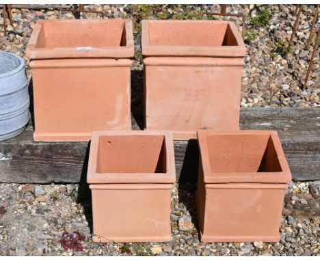 Four terracotta cube planter pots, two @ 26 cm h, two @ 21 cm h (4)