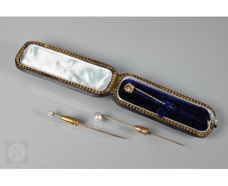 A diamond set yellow metal stick pin (cased) to/w two pearl-set stick pins (3) 