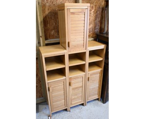 A pair of modern light oak narrow side cabinets, 35 x 35 x 120 cm to/w matching taller example, 35 x 35 x 180 cm high (3)