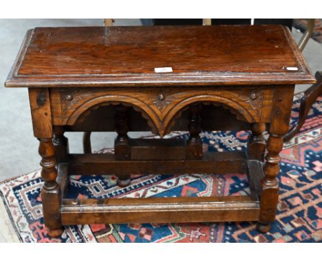 A carved oak gateleg side table with single drop leaf, turned supports with stretchers, jointed construction, 70 x 58 x 48 cm