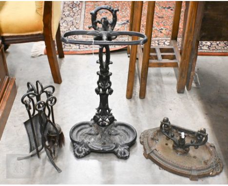 A Victorian cast iron boot-scraper, to/w a stick-tand and a fireside companion set (3)