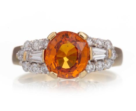 CERTIFICATED SAPPHIRE AND DIAMOND RING set with an orange sapphire of approximately 2.40 carats, flanked by round and tapered