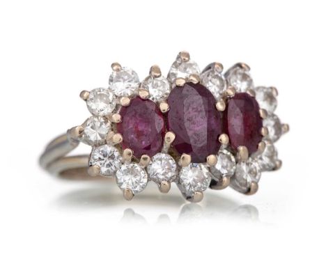 RUBY AND DIAMOND RING set with oval rubies within a halo of diamonds, marked 18, size G /2Qty: 5.2gWell worn. Rubies chipped.