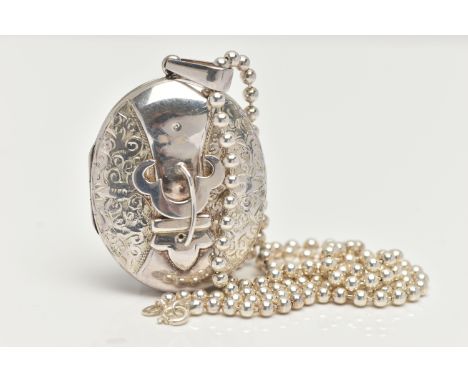 A WHITE METAL OVAL LOCKET WITH CHAIN, oval belt buckle detailed locket with a scrolling pattern, fitted with a tapered bail, 