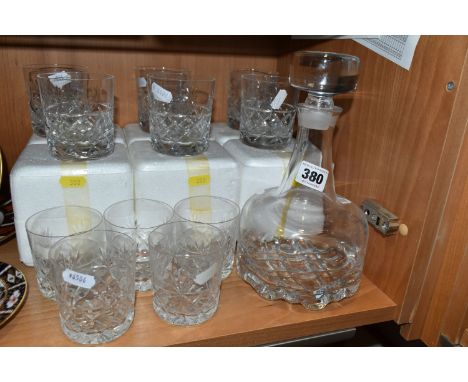 AN ORREFORS CLEAR GLASS DECANTER AND STOPPER WITH MOULDED GEOMETRIC DESIGN TO THE BASE, remnants of paper label and etched ma