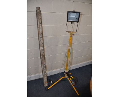 A SINGLE HEAD TRIPOD FLOODLIGHT along with a smaller clip on light (both PAT pass and working) and a telescopic surveyors mea