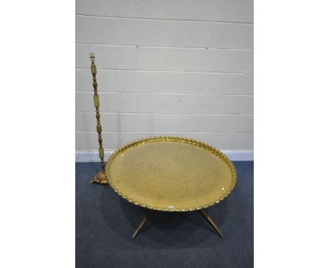 A LARGE ANGLO INDIAN BRASS TOP COFFEE TABLE, decorated with foliate detail surrounded  by moulded edge on a folding hardwood 