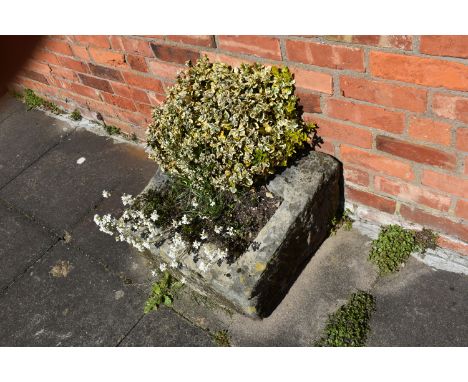 A VINTAGE SANDSTONE PUMP TROUGH width 54cm depth 57cm height 30cm at highest point with soil and planting Condition some loss
