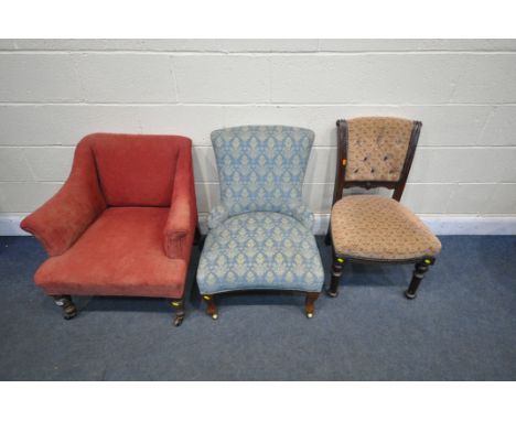 AN 20TH CENTURY RED UPHOLSTERED ARMCHAIR, on ceramic castors, along with a blue upholstered chair on brass castors, and anoth