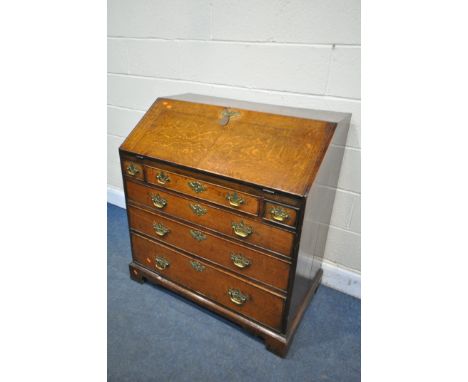A GEORGIAN OAK BUREAU, with a fitted interior over six exterior drawers on bracket feet, width 95cm x depth 57cm x height 101