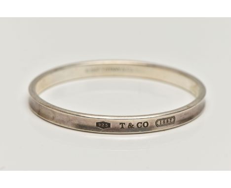 A 'TIFFANY &amp; CO' BANGLE, concaved bangle stamped '925 T&amp;Co 1837', signed to the interior of the band '1997 Tiffany &a