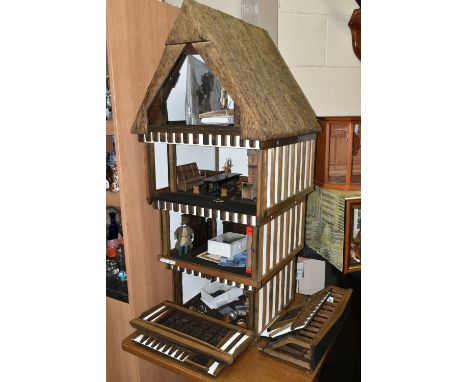 A FOUR STOREY TUDOR WOODEN DOLLS HOUSE, made by Robert Stubbs, model no. F1, detachable magnetic front walls open to reveal f