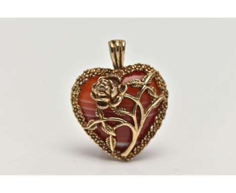 A 9CT GOLD BANDED AGATE HEART PENDANT, polished orange and white agate heart within a floral detailed mount, fitted with a ta
