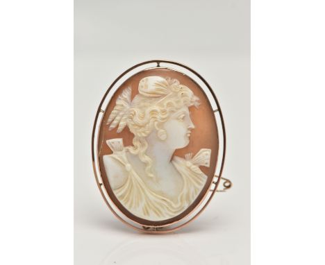 A CAMEO BROOCH, oval carved shell cameo depicting a lady in profile, collet set in a rose metal mount, part stamp 9ct, fitted