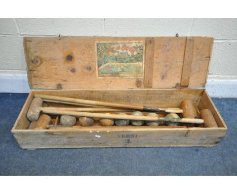 A VINTAGE FRENCH CROQUET SET, in a pine case, the inner lid reading 'Jeu De Croquet' (condition:- incomplete, historical wood